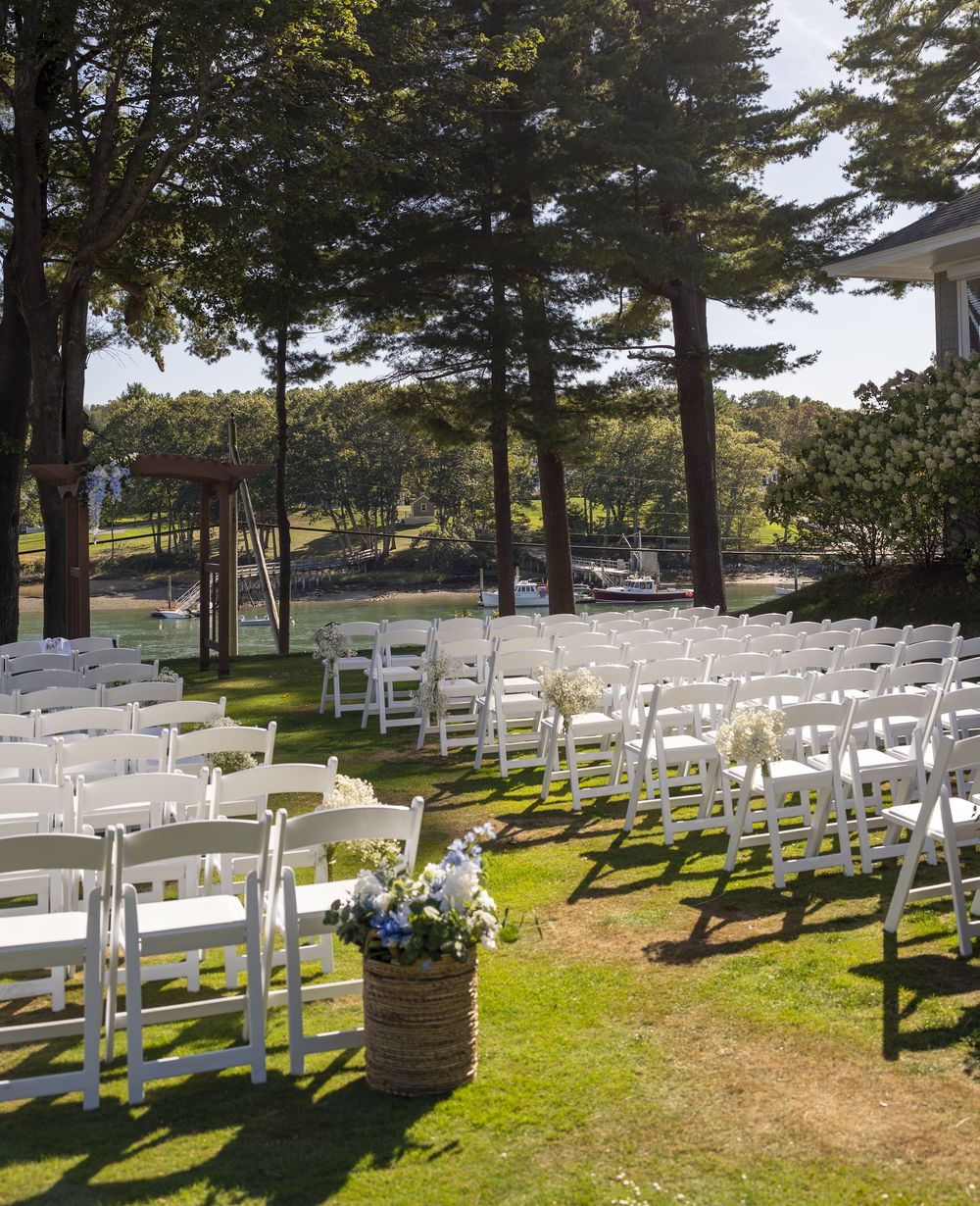 Coastal Maine wedding at the York Golf & Tennis Club featuring a waterfront ceremony, elegant blue‑and‑white country‑club reception décor, l