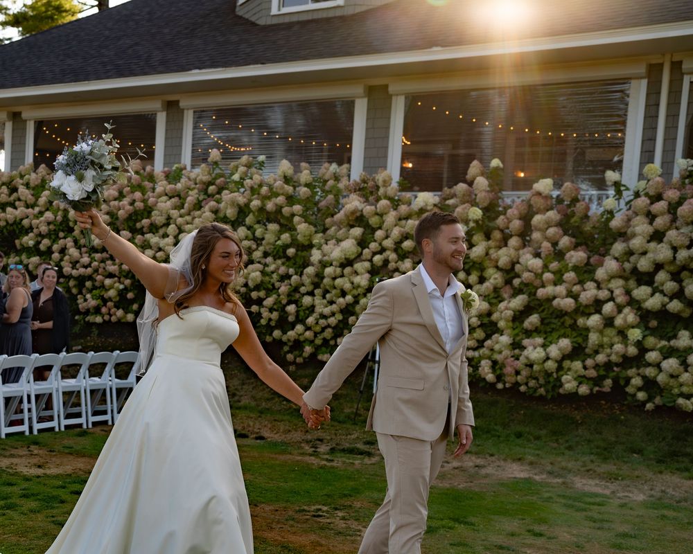 Coastal Maine wedding at the York Golf & Tennis Club featuring a waterfront ceremony, elegant blue‑and‑white country‑club reception décor, l