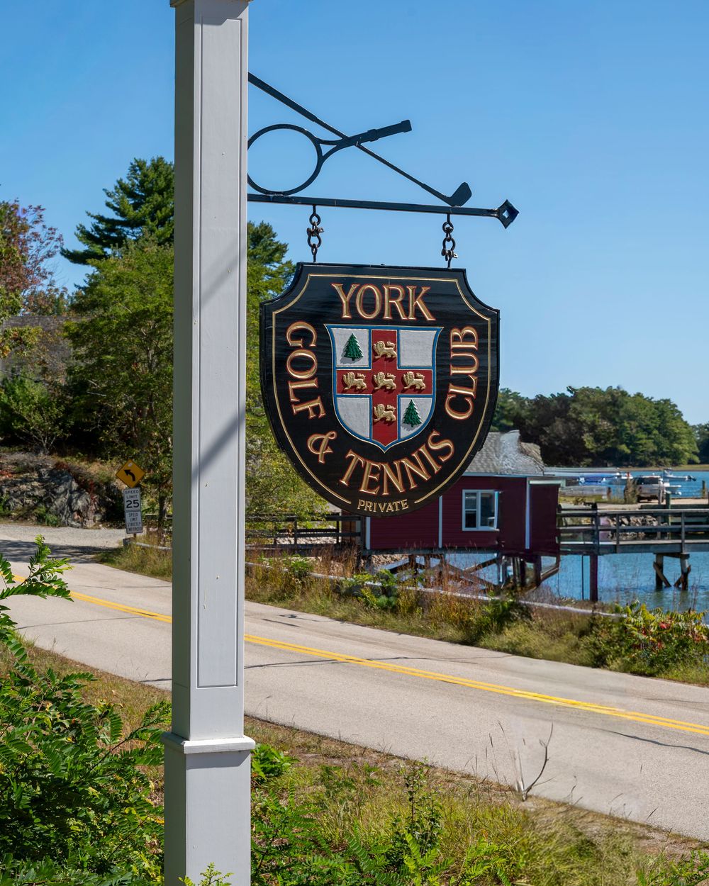 Coastal Maine wedding at the York Golf & Tennis Club featuring a waterfront ceremony, elegant blue‑and‑white country‑club reception décor, l