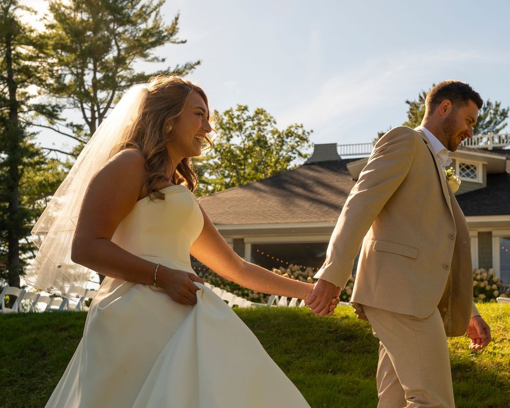 Coastal Maine wedding at the York Golf & Tennis Club featuring a waterfront ceremony, elegant blue‑and‑white country‑club reception décor, l
