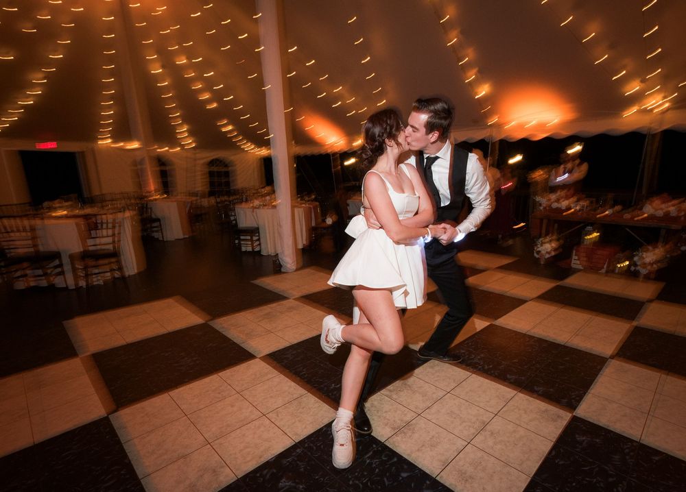 A sequence of dance moves on a tiled floor captured in low light conditions during what appears to be a reception.