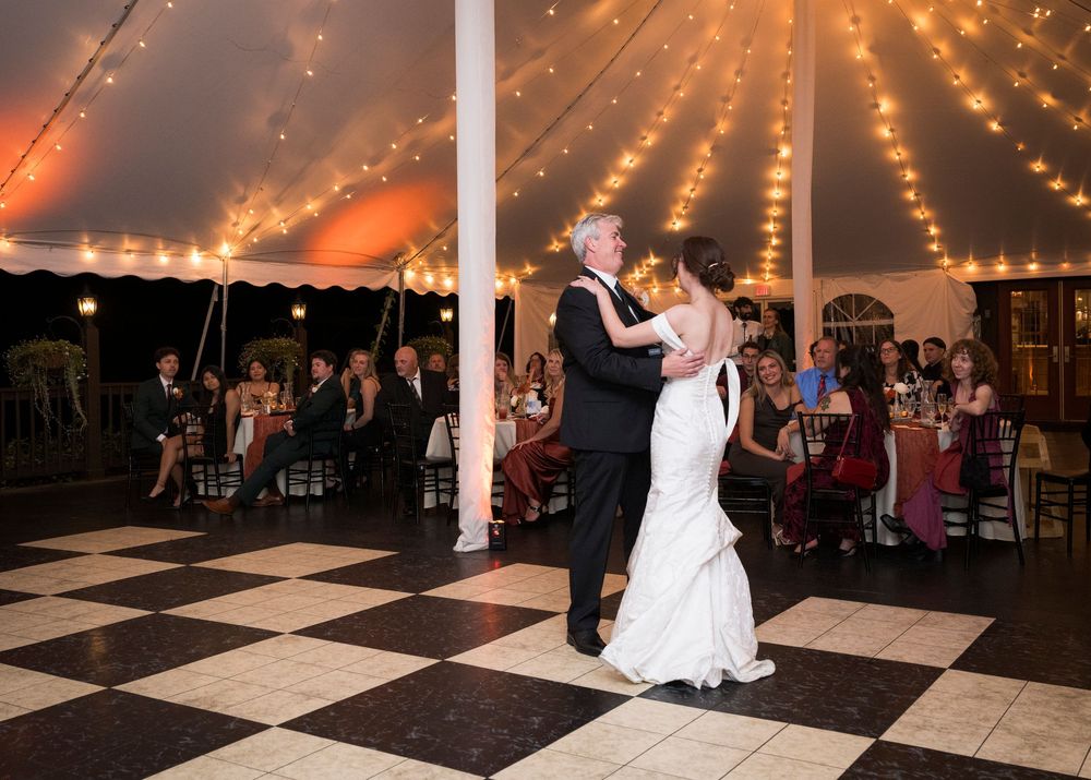 Wedding reception dance floor with string lights creating a romantic atmosphere.