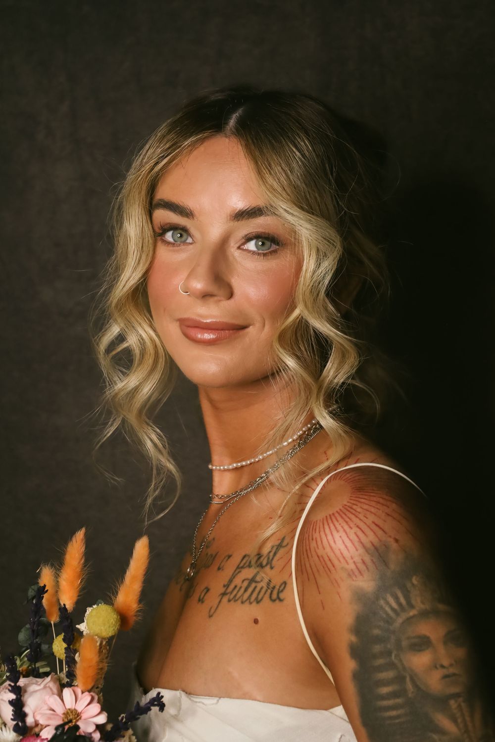 A series of artistic portrait photos showing a blonde model posing against a dark background with floral accents.