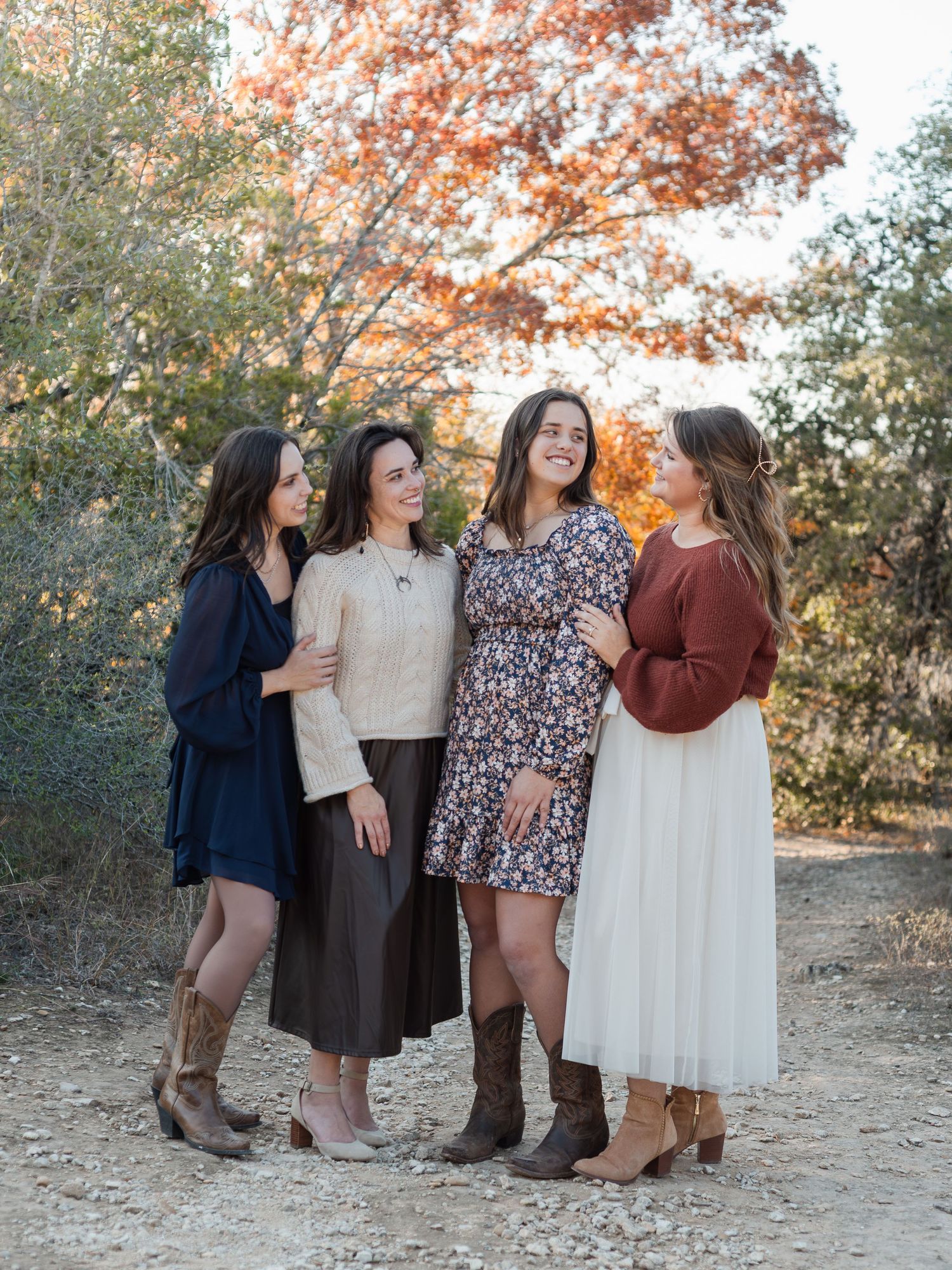 Sisters laughing together during extended family session at McKinney Falls State Park in Texas