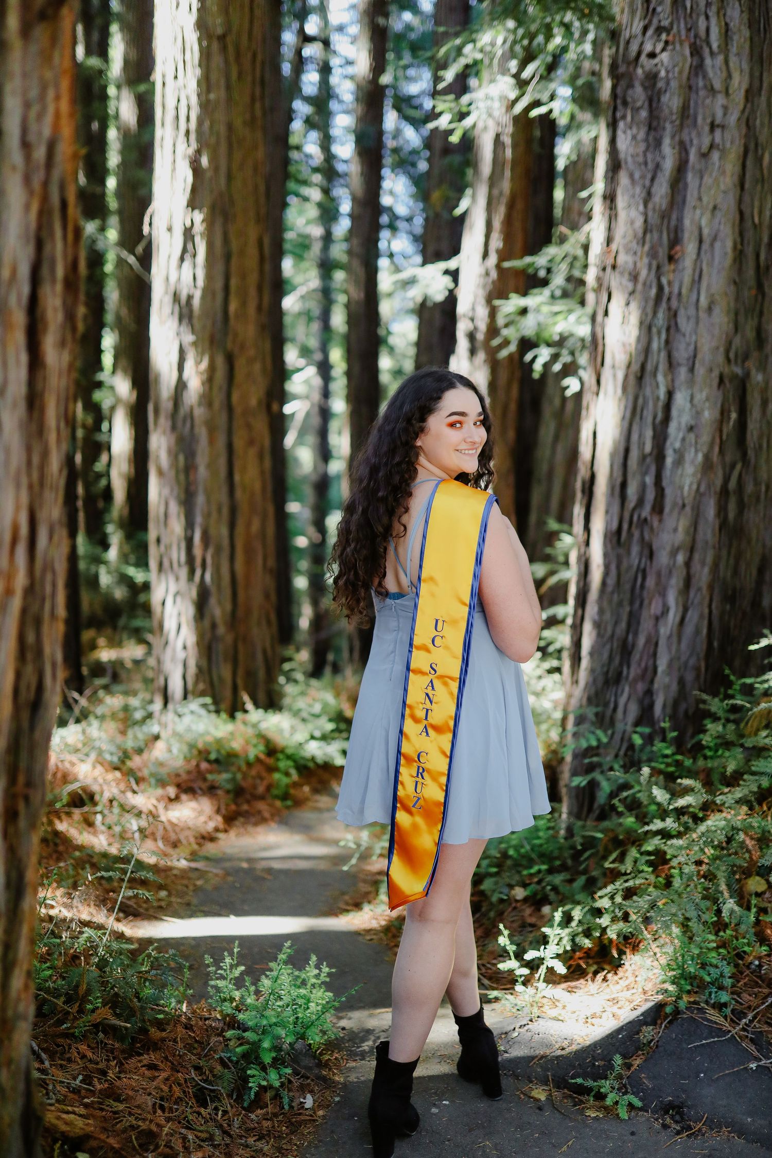 College grad takes her graduation pictures at the redwoods of UC Santa Cruz.