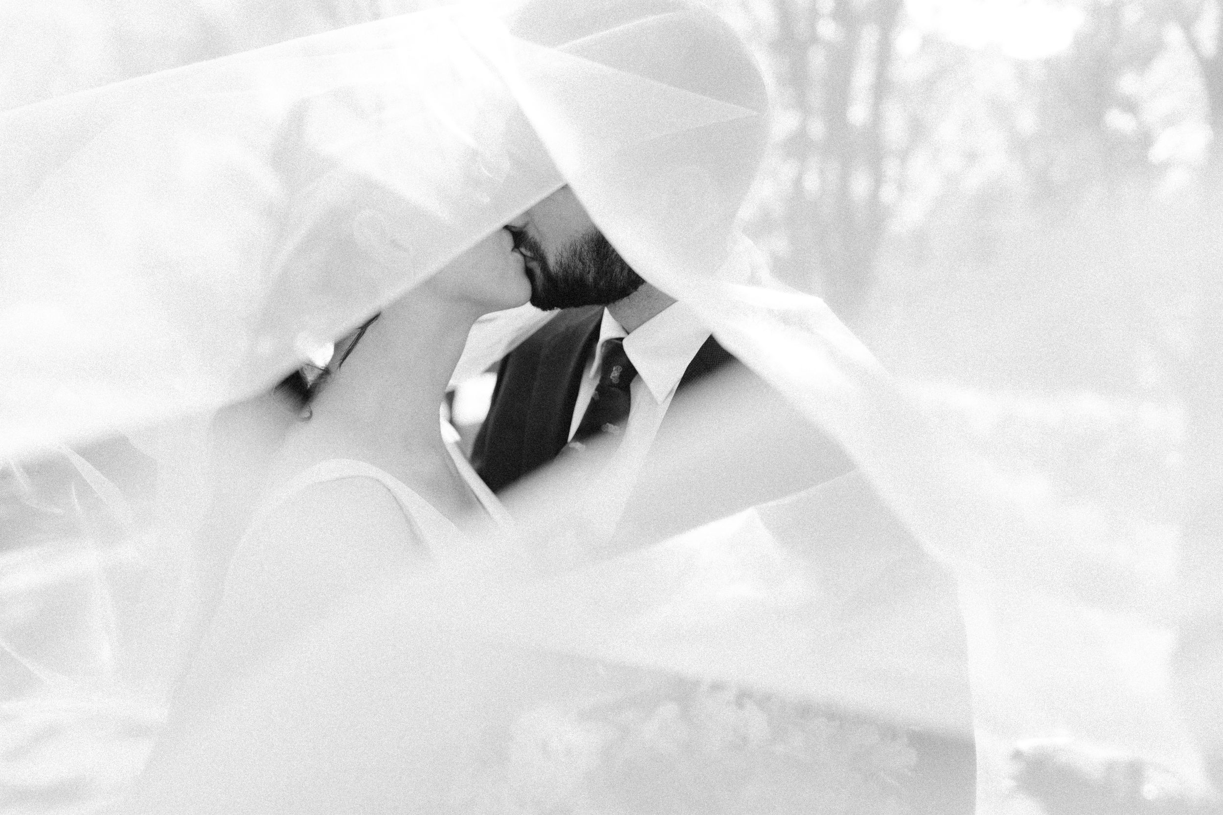 Ethereal black and white wedding photography with flowing fabric and movement.