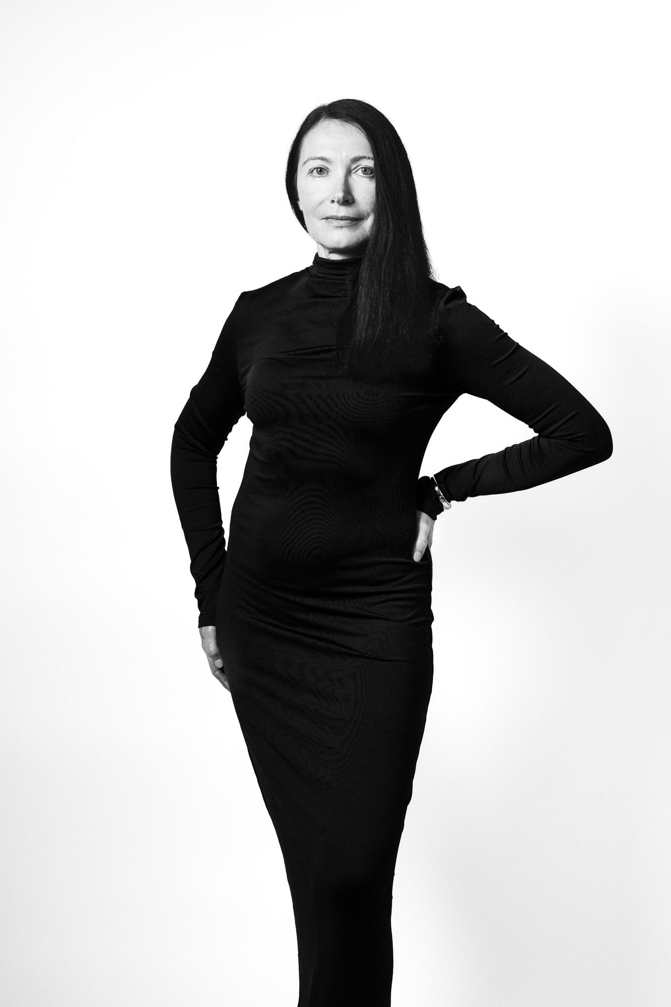 Full length black and white studio portrait of a confident woman taken in a studio in King's Lynn,  Norfolk