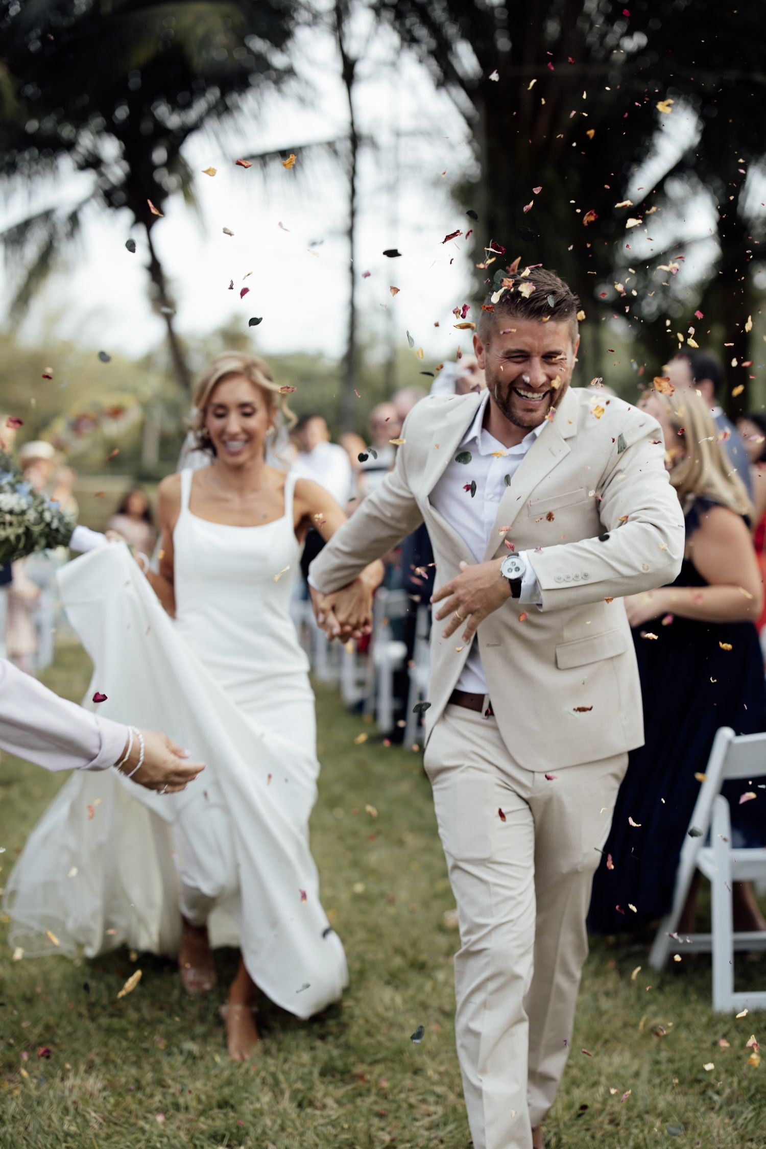 Jupiter Wedding Photo Gallery of colorful confetti exit with couple earth tones at sustainable Jupiter Creamery tropical garden venue.