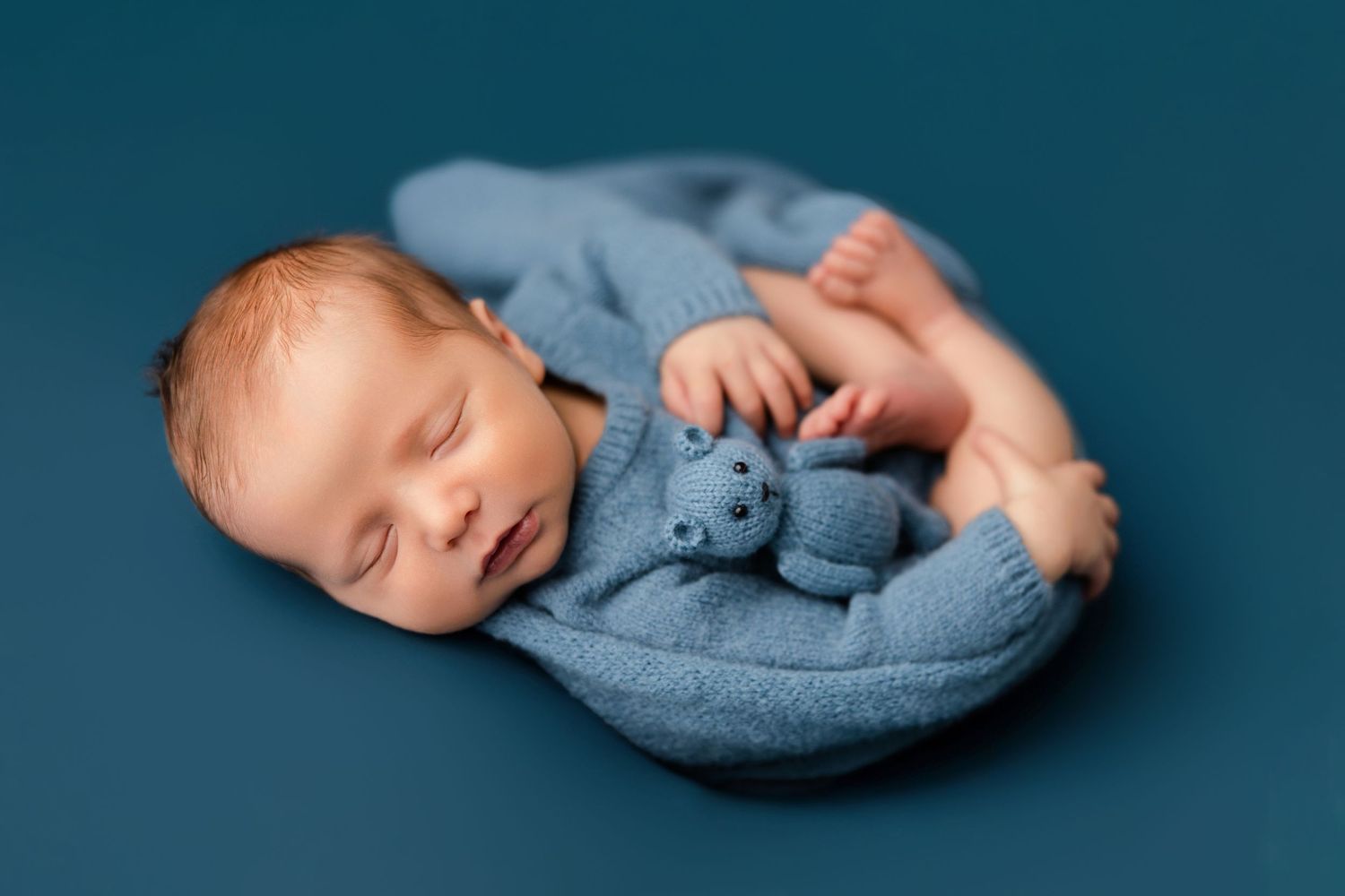 Carefully posed newborn boy with bear lovey portrait captured during a Middle Tennessee newborn photography session