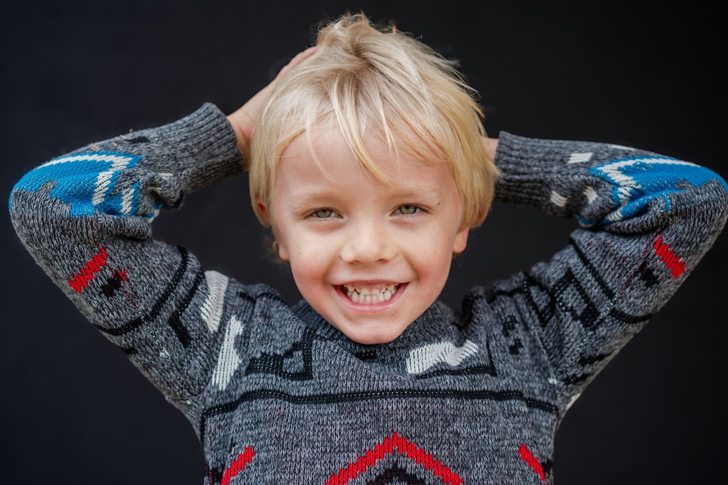 School personality portrait of a young boy with his hands behind his head