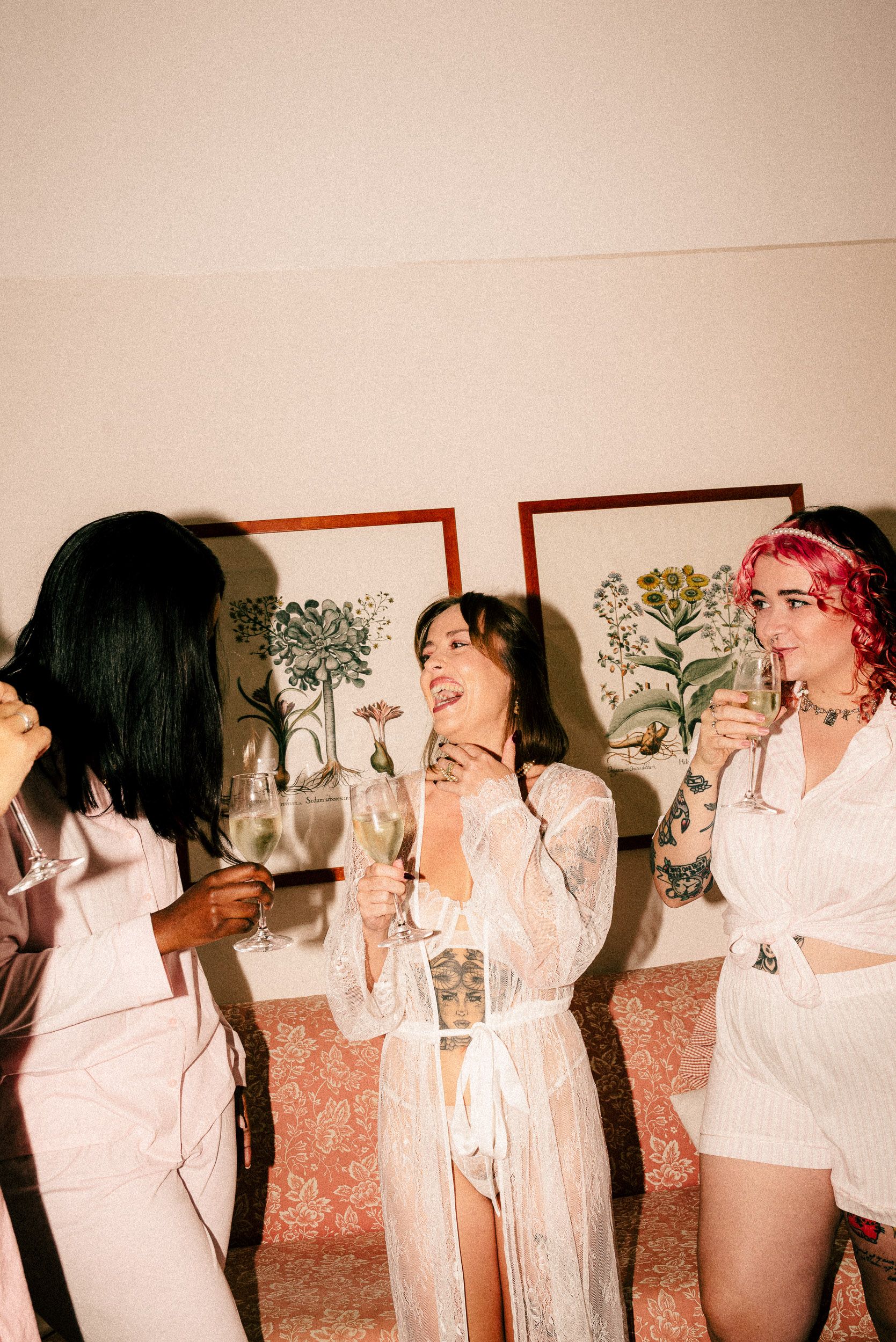 A sequence of five overlapping photos showing people in white outfits drinking and posing against a wall with botanical prints.