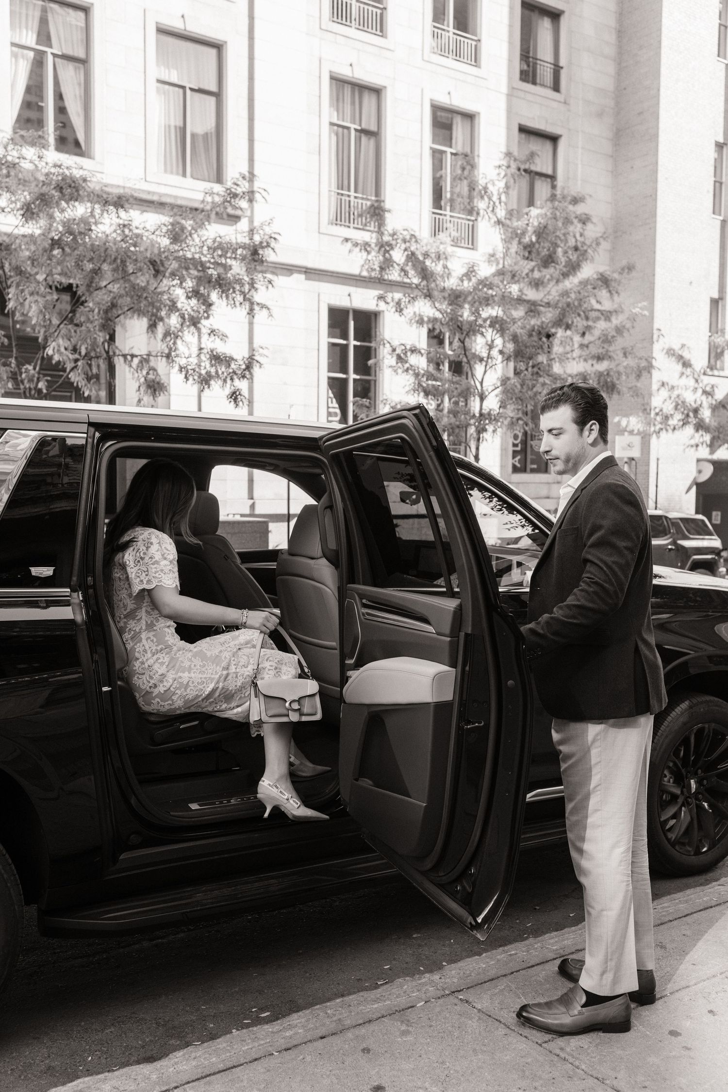 A sequence of black and white photos showing someone getting into the back seat of a luxury car on a city street.