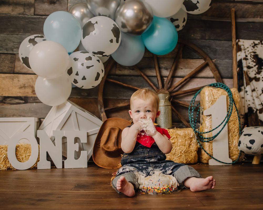 Birthday celebration setup featuring cake smash, rustic decor, and farmhouse-style decorations.