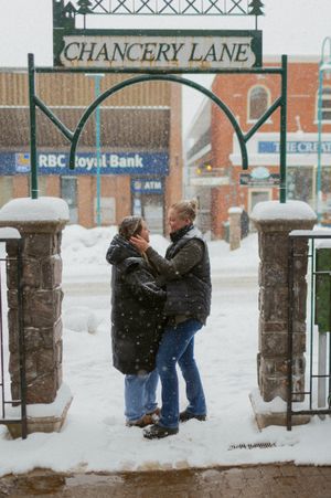 A romantic winter scene under the Chancery Lane sign entrance during snowfall.