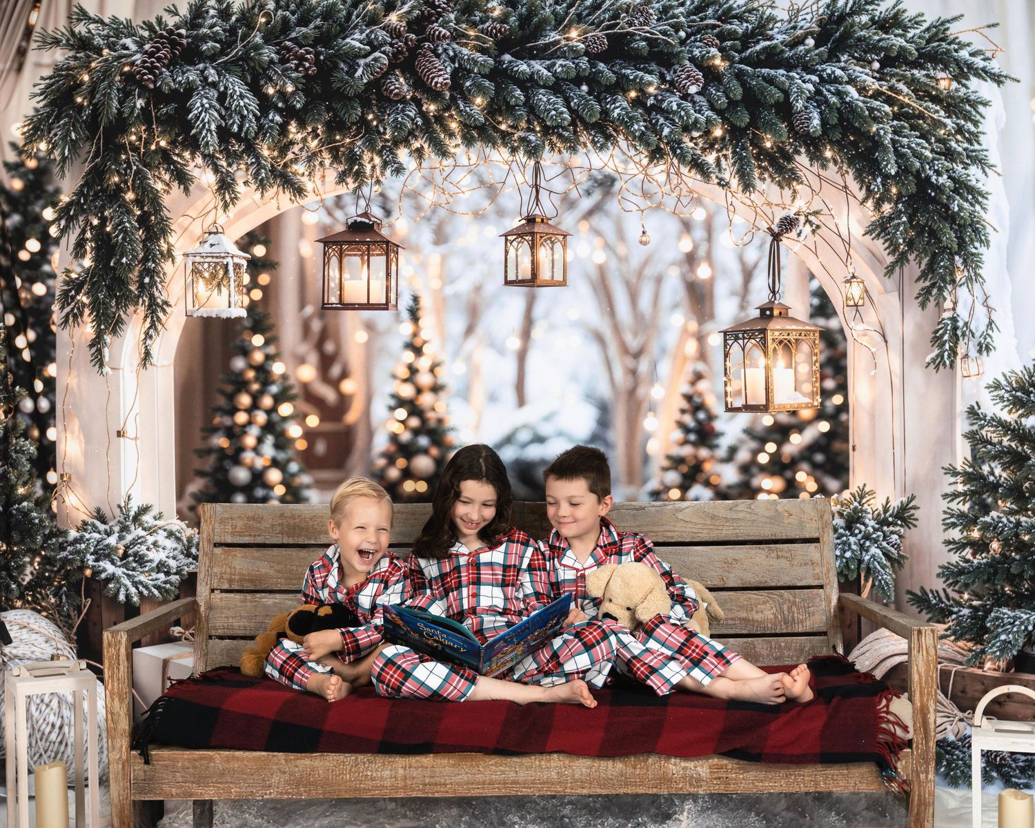 Rustic wooden bench decorated with evergreen garland, lanterns, and cozy red plaid blankets for Christmas.