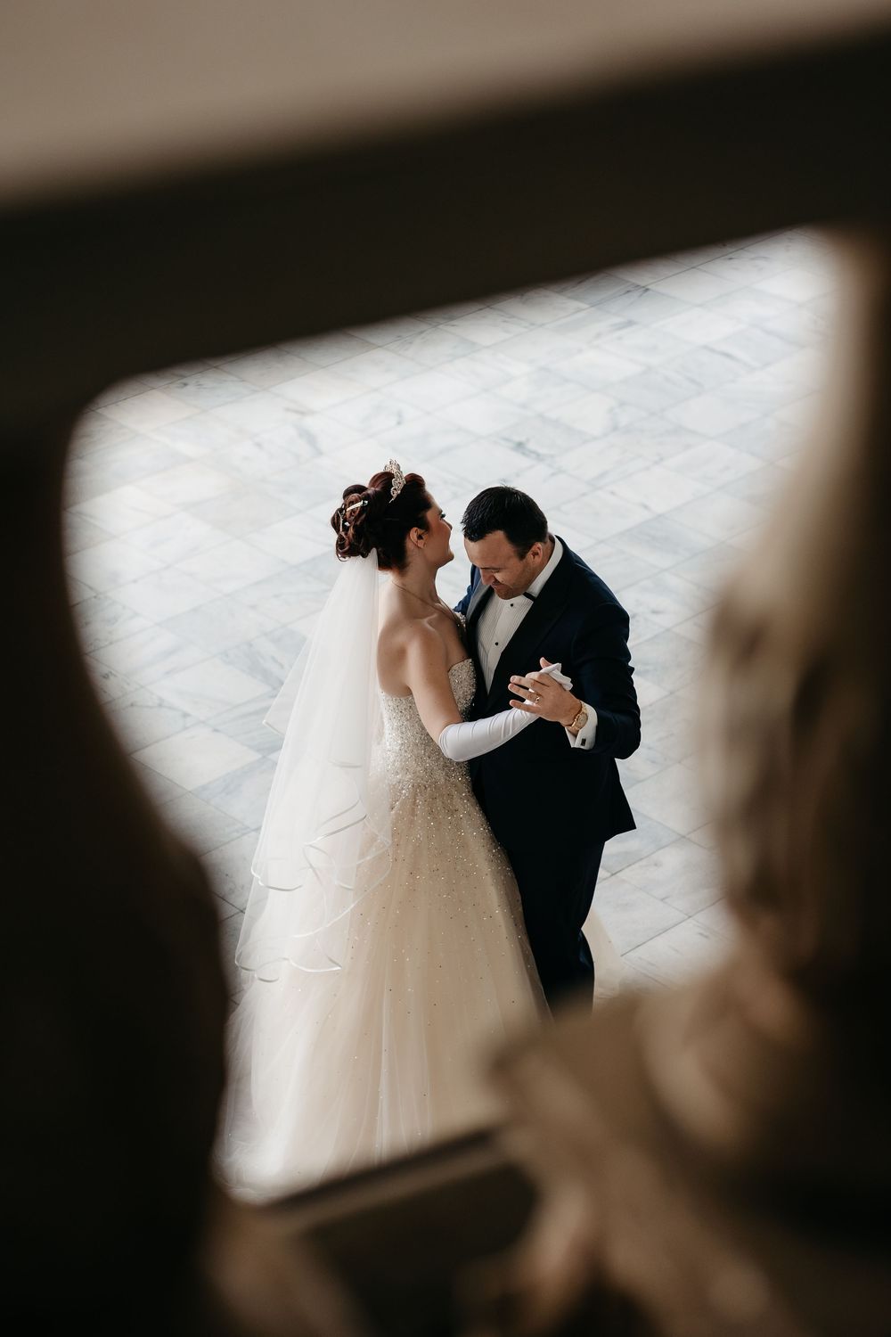 A romantic wedding photo sequence showing tender moments between a couple in black and white through window frames.