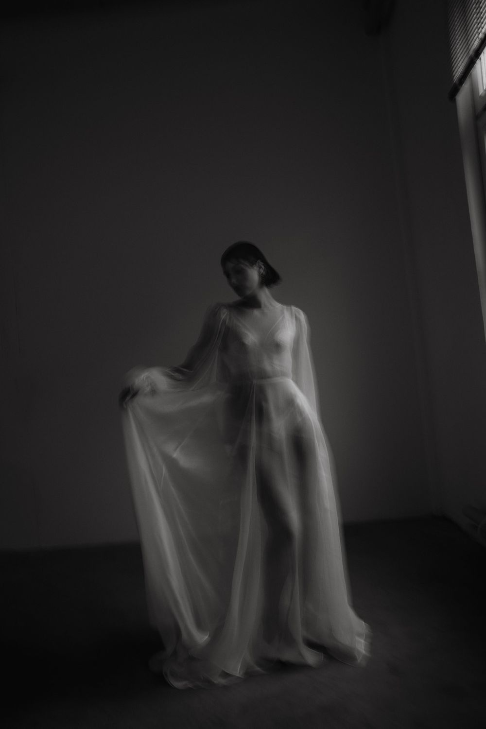 Artistic black and white photos of flowing white fabric creating ethereal movement.