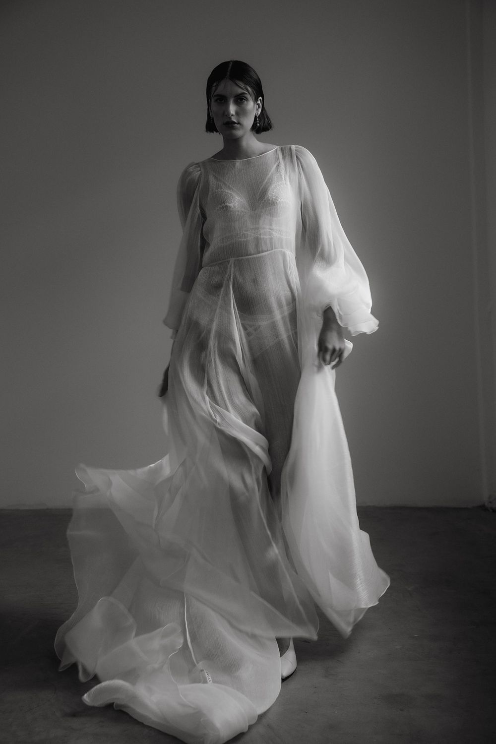 Moody black and white portraits featuring flowing sheer white dress.