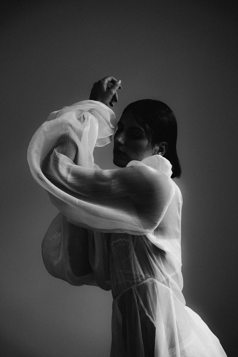 Dramatic black and white photos showing movement of sheer fabric.