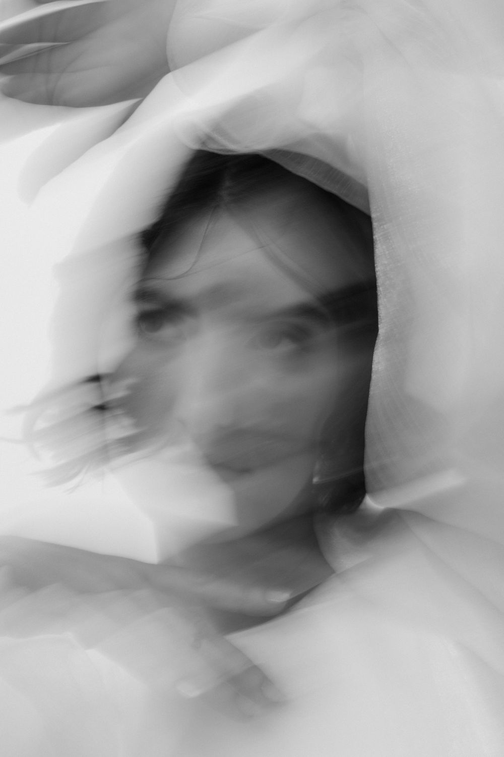 Abstract white fabric motion blur creating ethereal patterns and shapes.