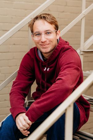 A person in a burgundy hoodie sits on stairs with white railings in a multi-panel photo sequence.
