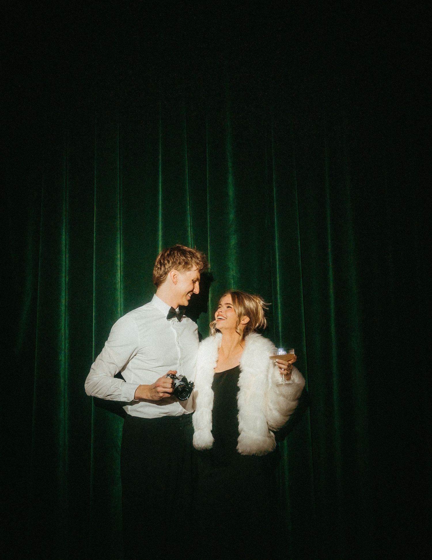 A romantic couple in vintage clothing share an intimate moment framed by delicate floral illustrations.