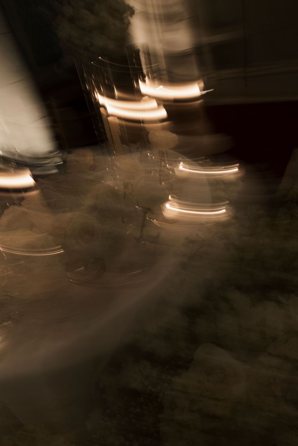 Blurred abstract night photography capturing swirling warm lights and motion at an outdoor evening event.