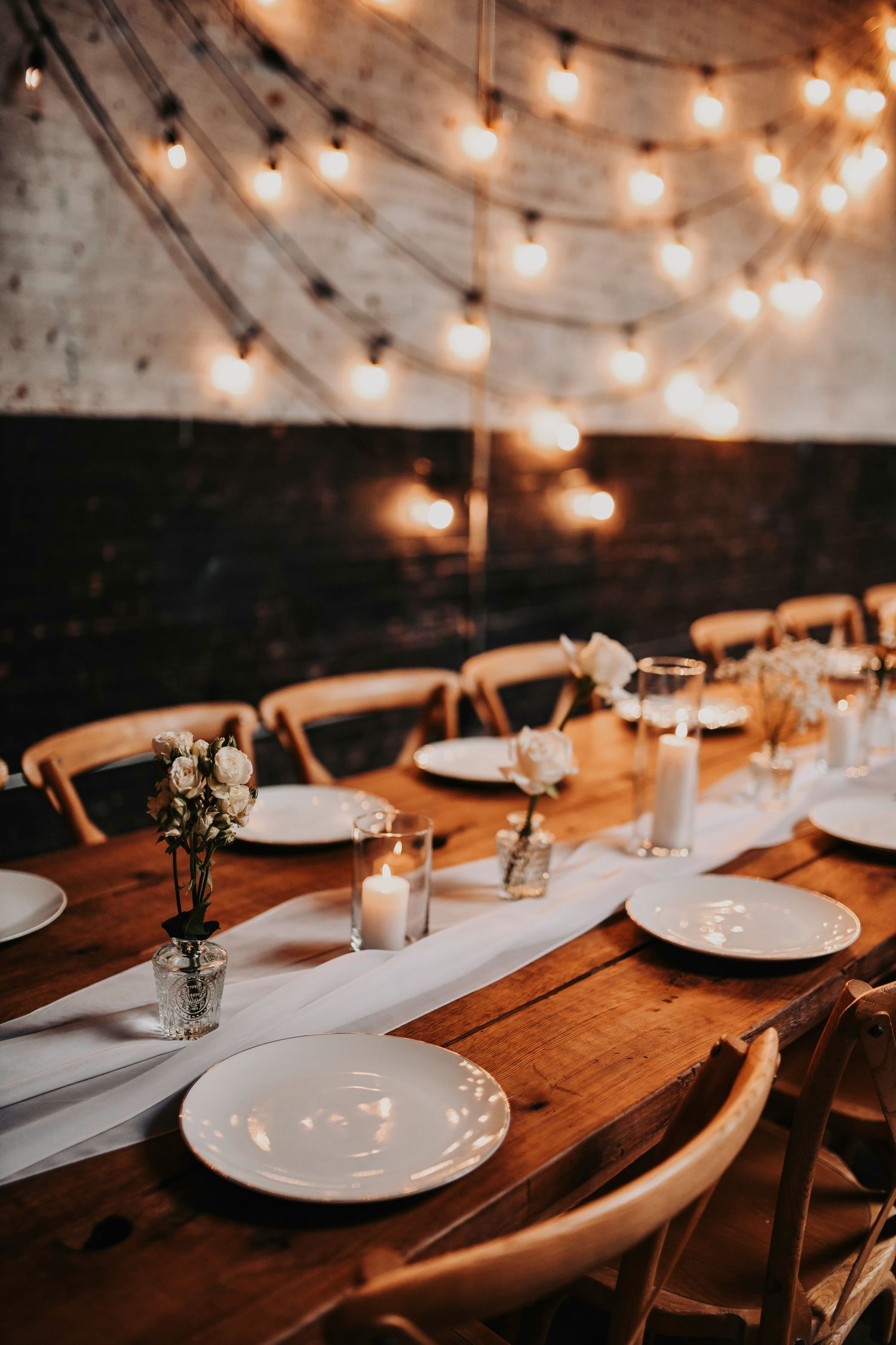 amber light cascades over the reception hall for this romantic tablescape at brake and clutch wedding venue