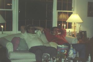 Family gathering in a warmly lit living room during an evening celebration.
