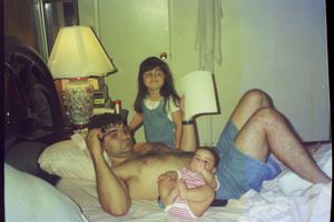 People relaxing together on a bed in a casual indoor setting.