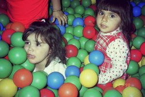 Colorful ball pit filled with red, blue, and green plastic balls.