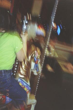 Blurred motion shots of people in casual clothes moving in a dimly lit space.