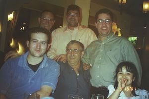 People sitting together at a restaurant table during what seems to be a dinner gathering.