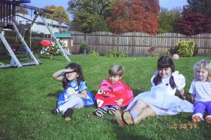 People relaxing together on grass during an autumn day outdoors.