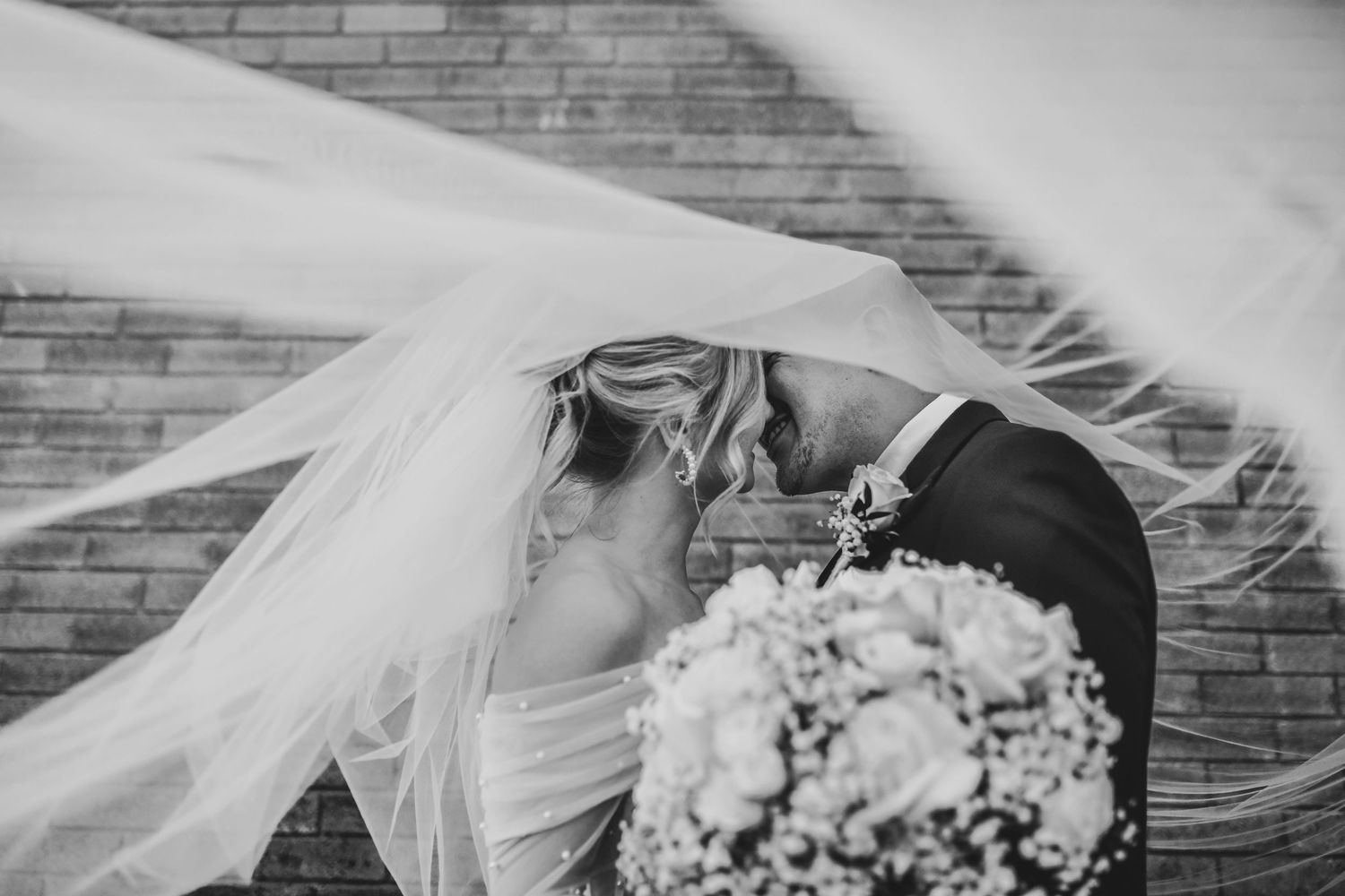 Bride and groom sharing a quiet moment in Deep Ellum’s arts district, photographed with soft, natural light and a modern aesthetic