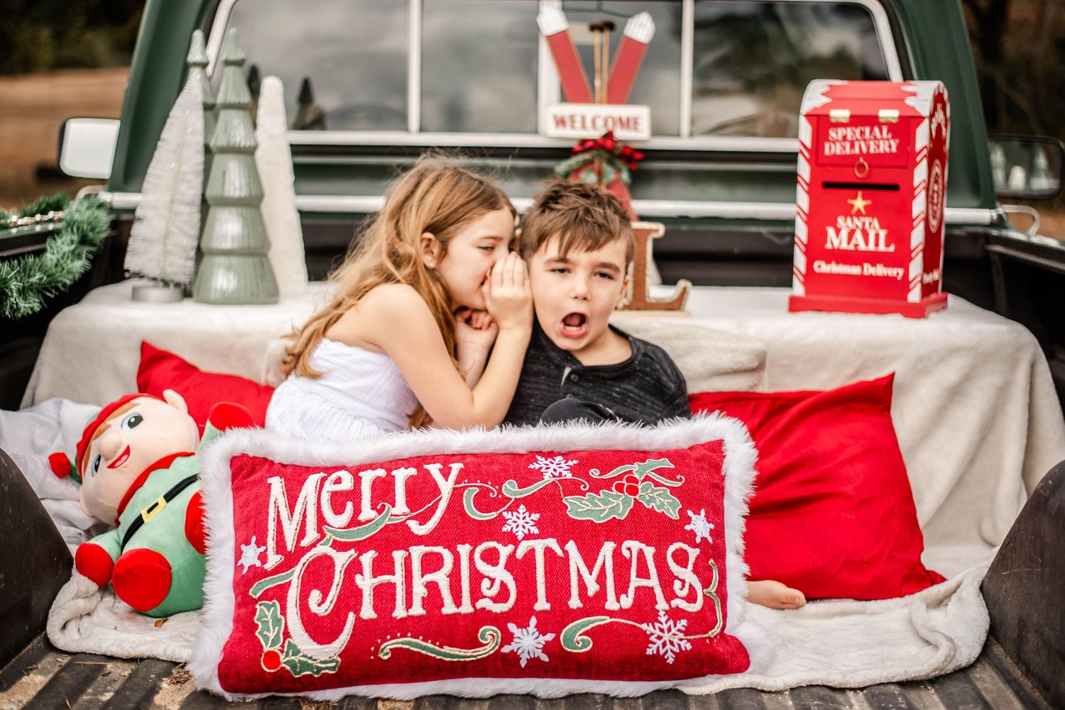 A festive red and white Christmas pillow displayed in multiple scenes with holiday decor and car interior settings.