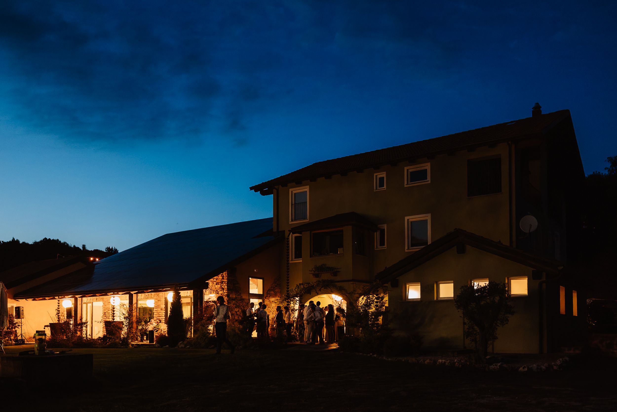 A series of dusk photos showing a house exterior with glowing windows against a darkening blue sky and mountains.