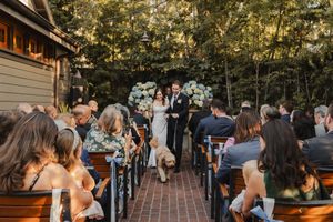 Candid moment of the couple smiling as they walk down the aisle in Pasadena