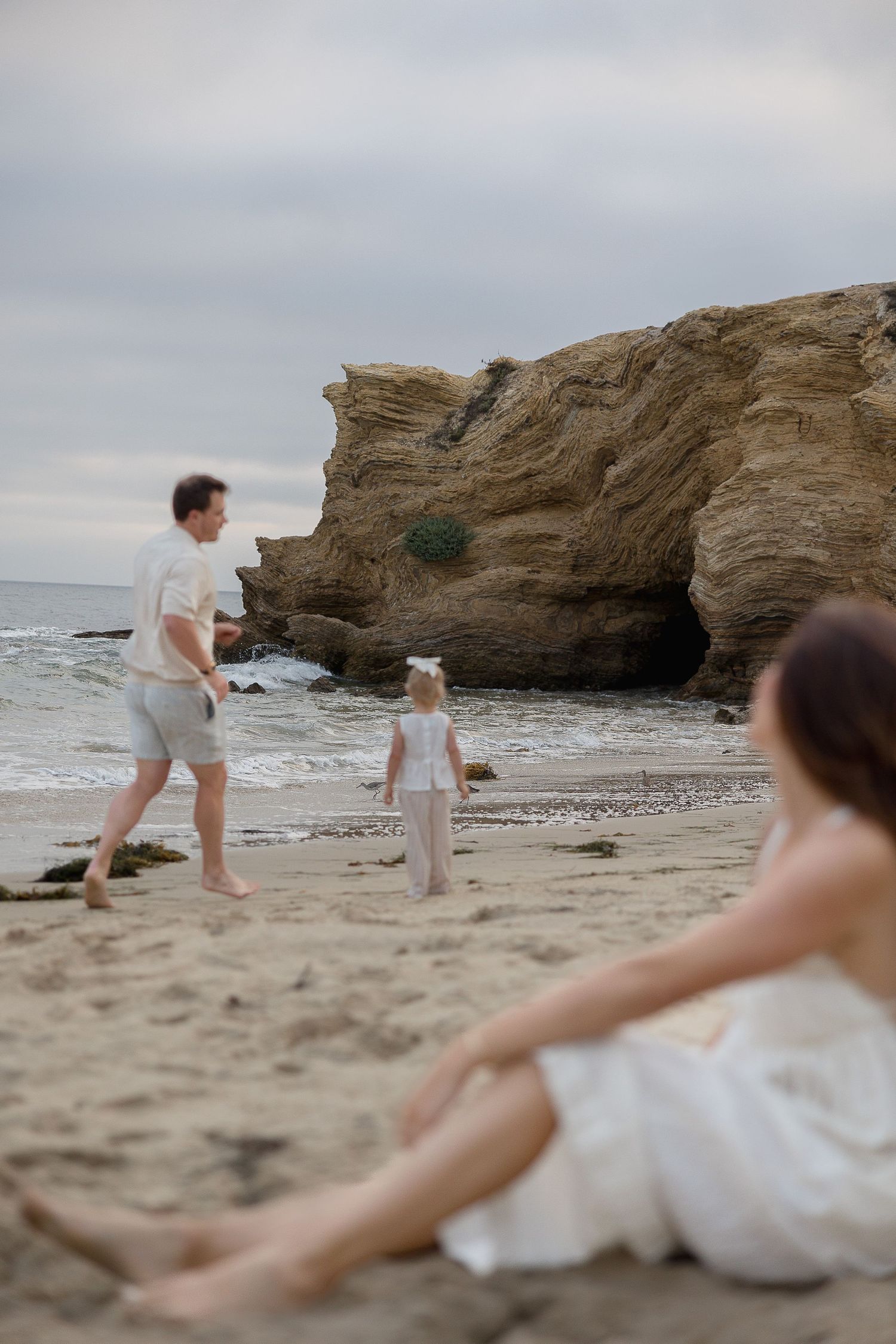 Crystal Cove beach family photos with a child running along the shoreline