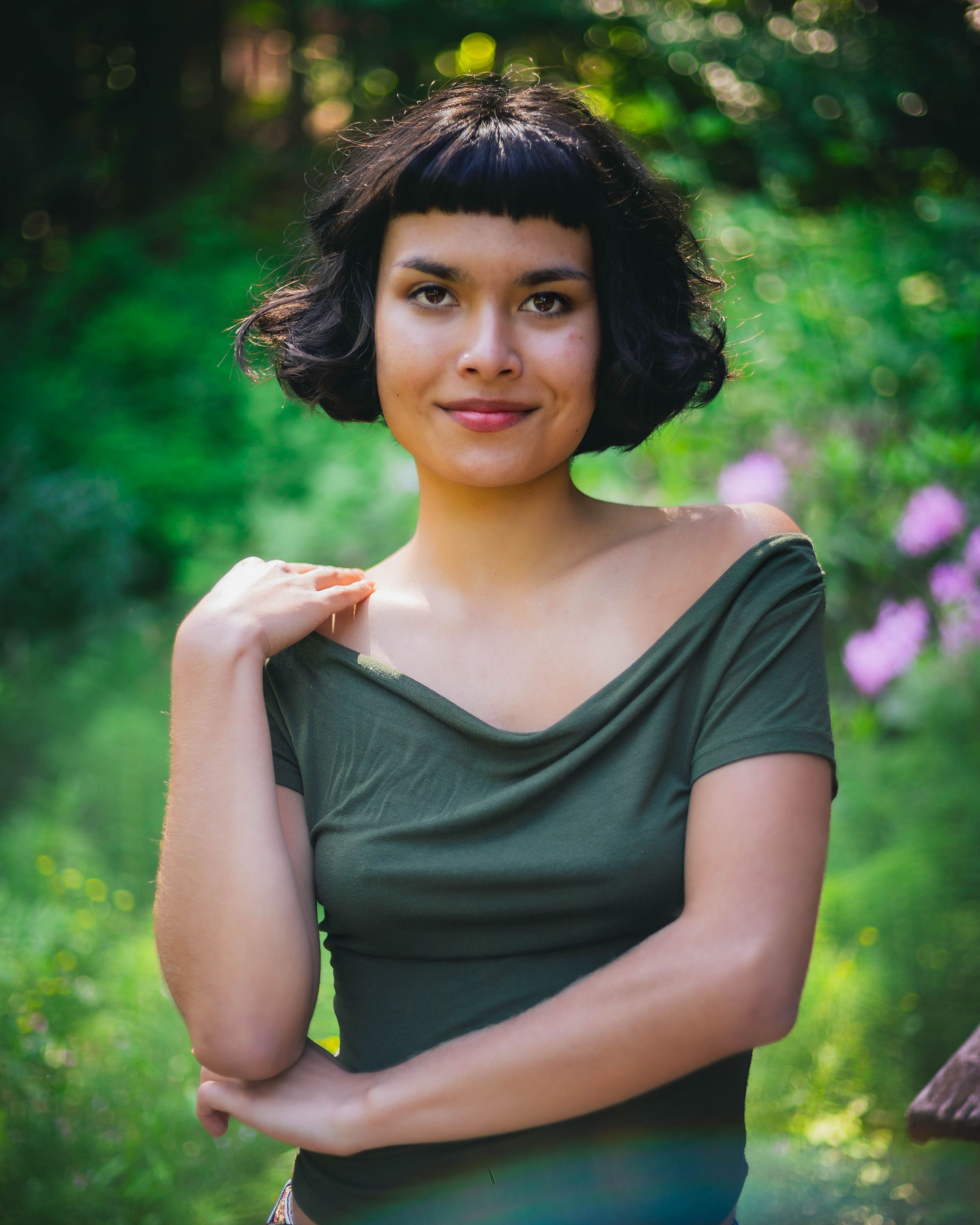 Girl in green stand in a lushes green forest