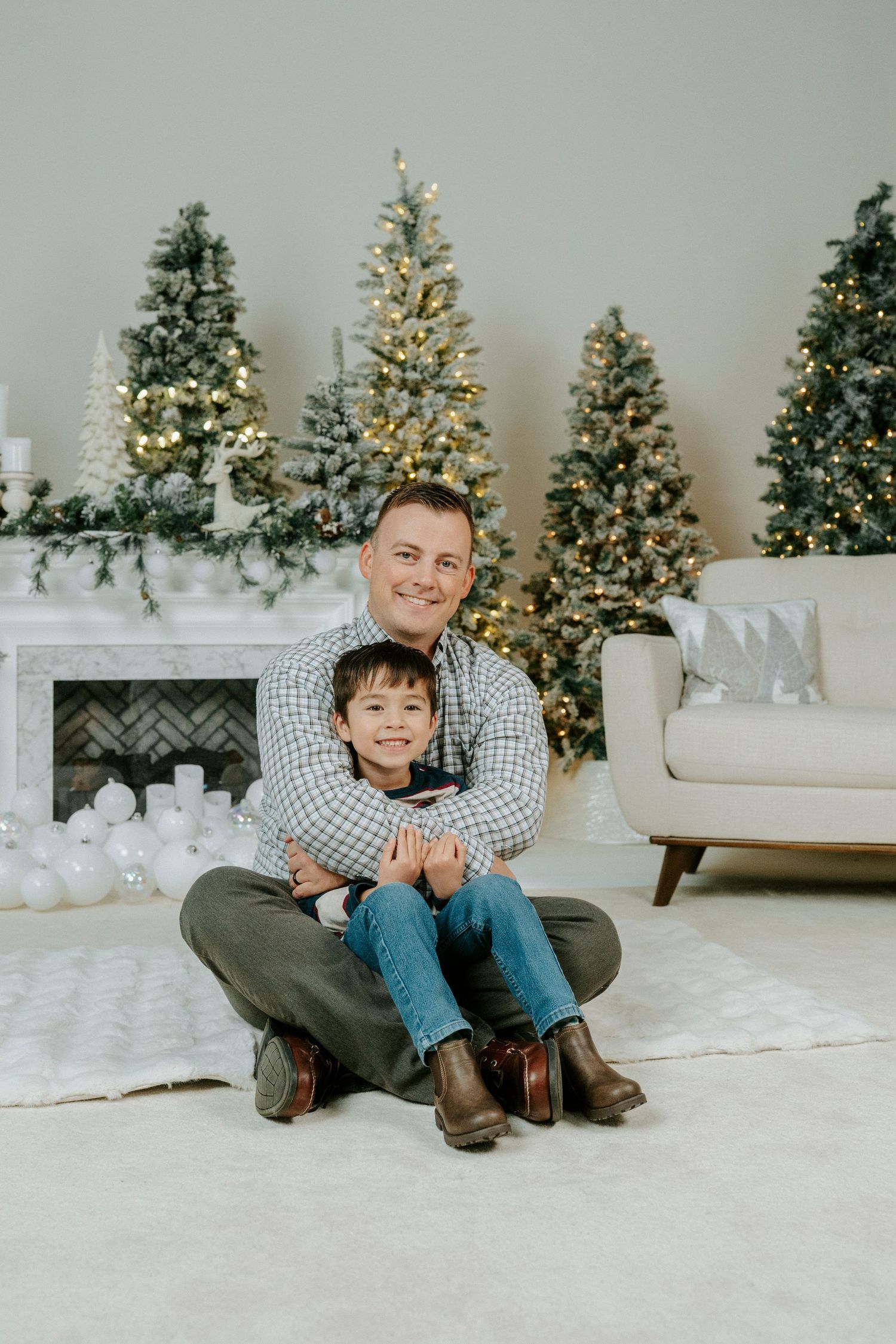 A festive holiday scene with decorated Christmas trees and white decor creating a cozy winter atmosphere.