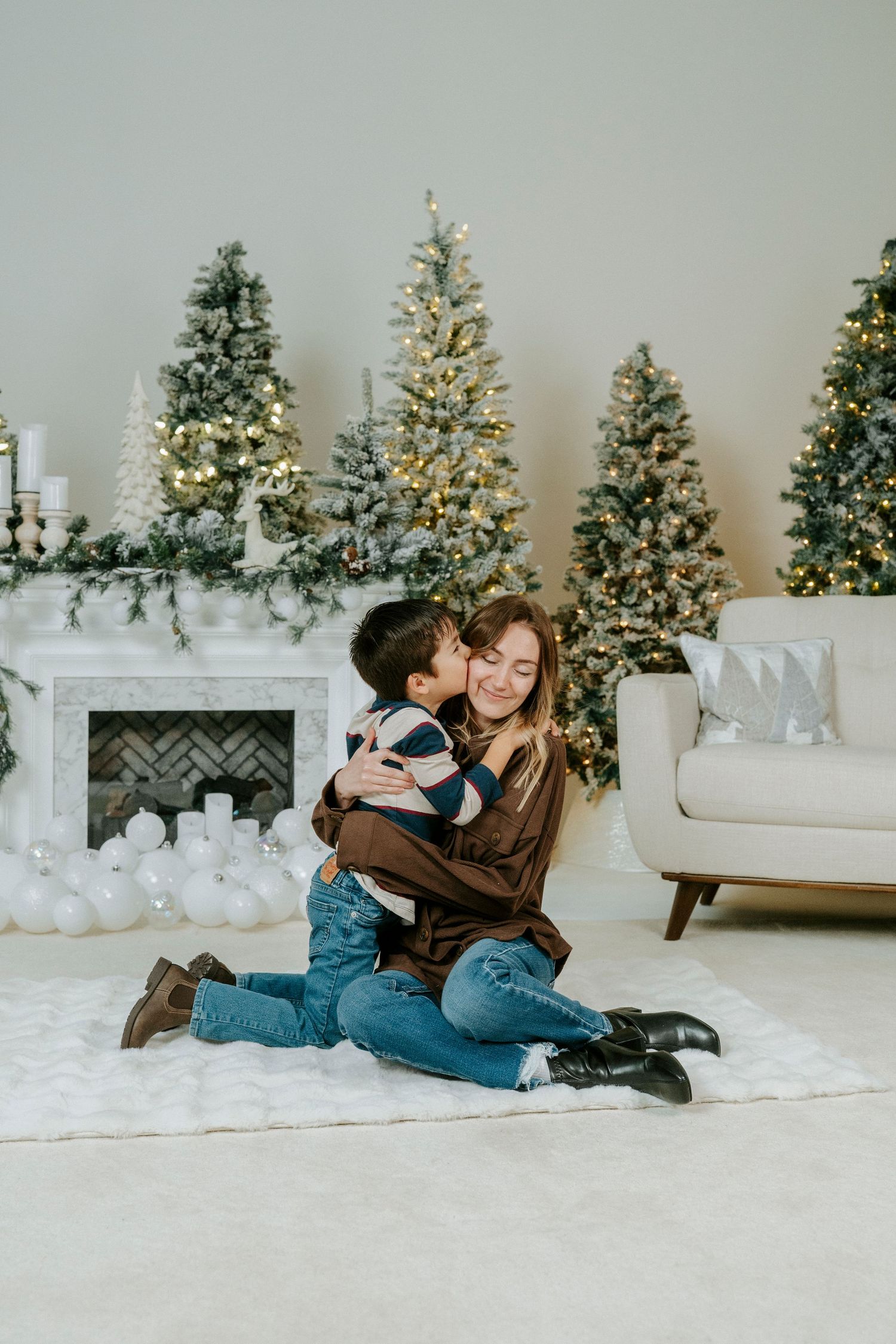 A festive winter scene with decorated Christmas trees and white decor creating a cozy holiday atmosphere.