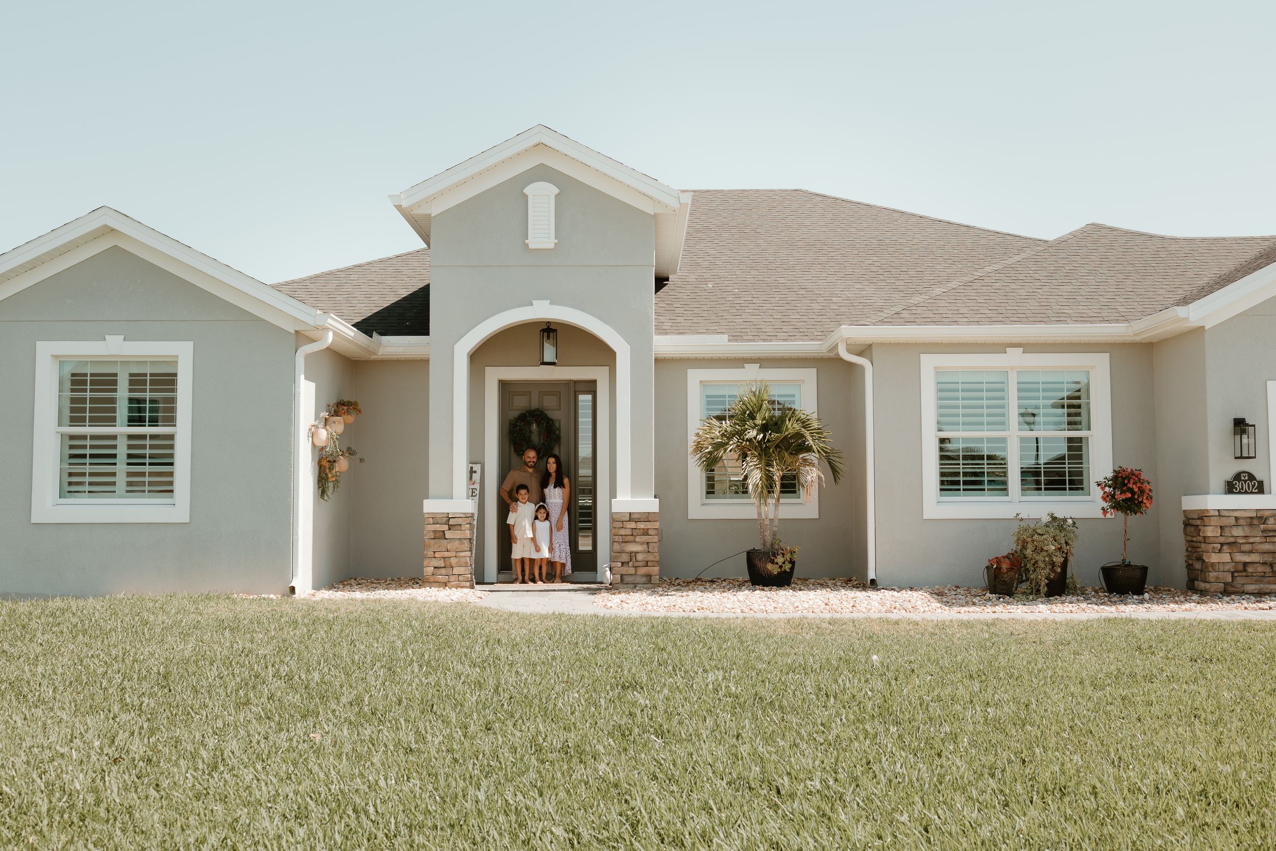 Exterior view of modern suburban homes with well-maintained lawns.