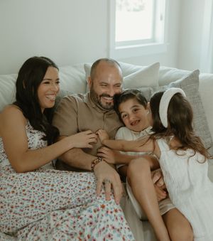 A family sharing a tender moment together on a cozy couch.
