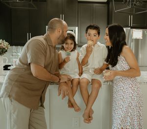 A sequence of candid family moments showing playful interactions in a modern kitchen setting.