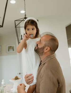 A series of tender family interactions captured in a bright indoor setting.