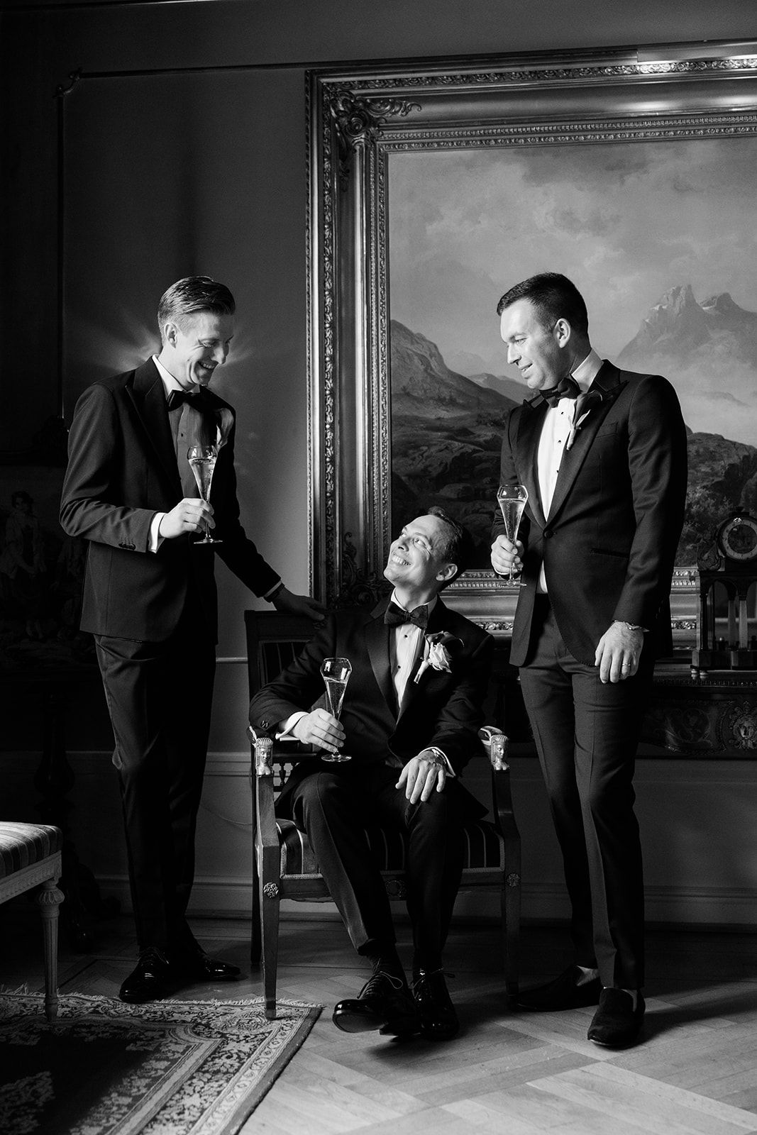 A series of black and white photographs showing two people in formal attire interacting in an elegant room with framed artwork.
