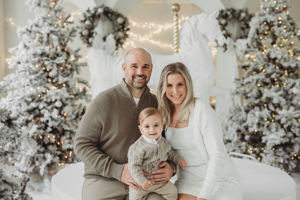 Family posing together for Christmas card photo during studio holiday family portrait session in Toronto