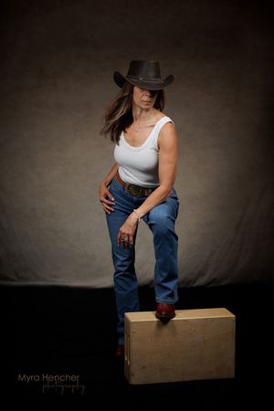 A series of artistic photographs showing someone in jeans and tank top sitting on a wooden box against a dark backdrop.