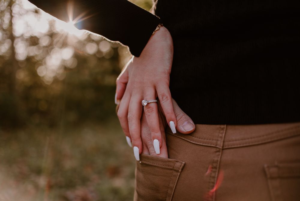 Close-up detail shot highlighting hands and warm sunlight in an outdoor setting.